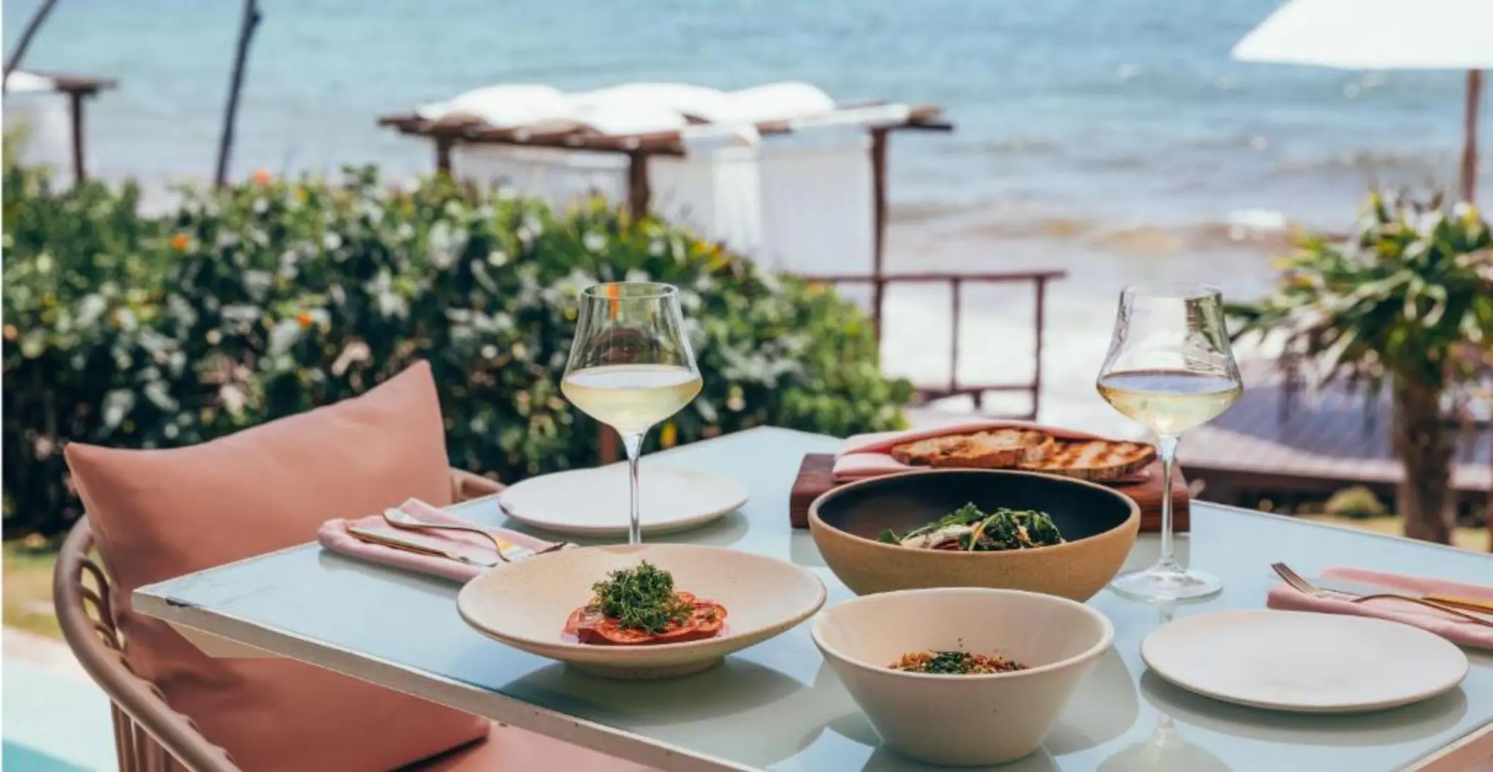 a seafront table setup with food at Mi Amor