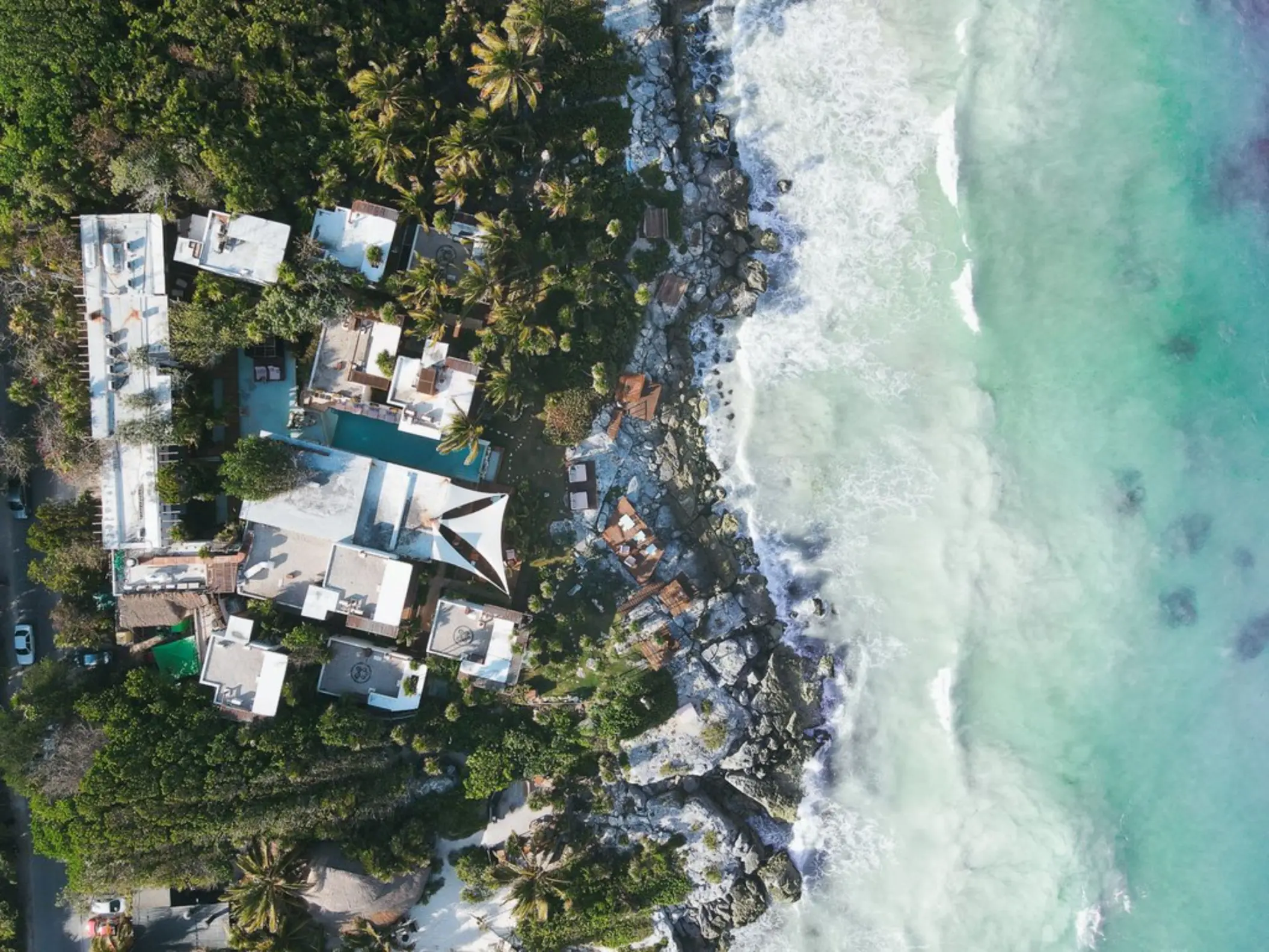 aerial view of Mi Amor hotel with its beach and palms