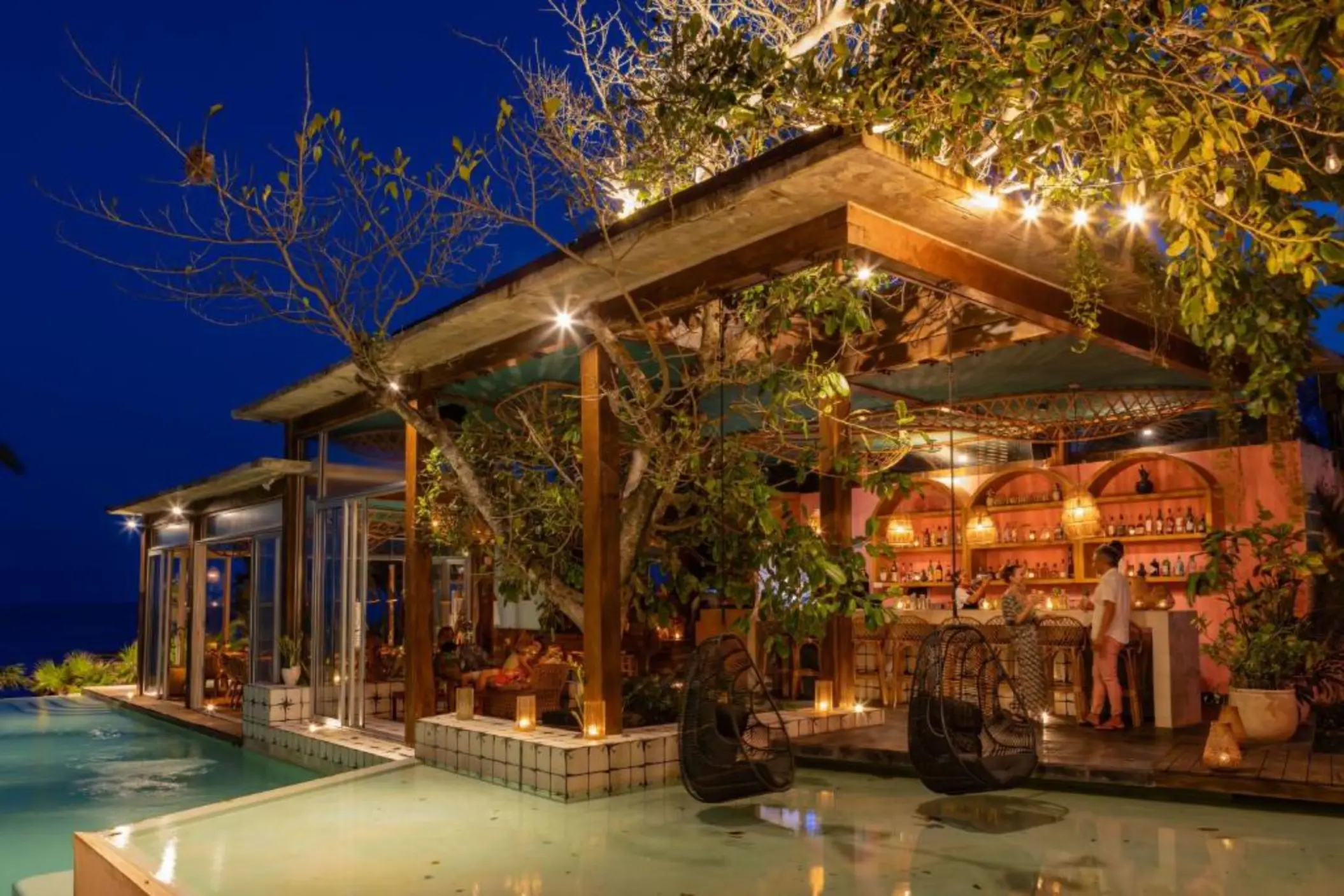 poolside bar at night at Mi Amor