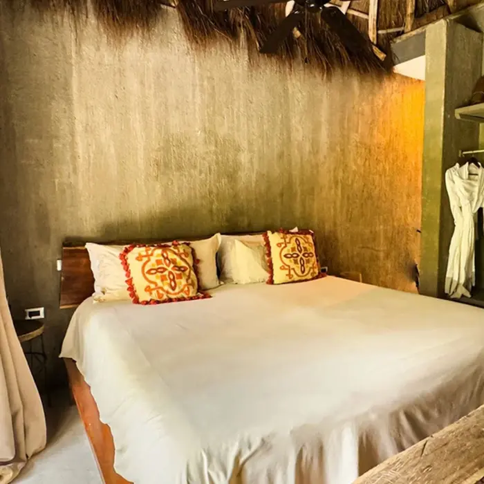 king bed inside room at nomade tulum