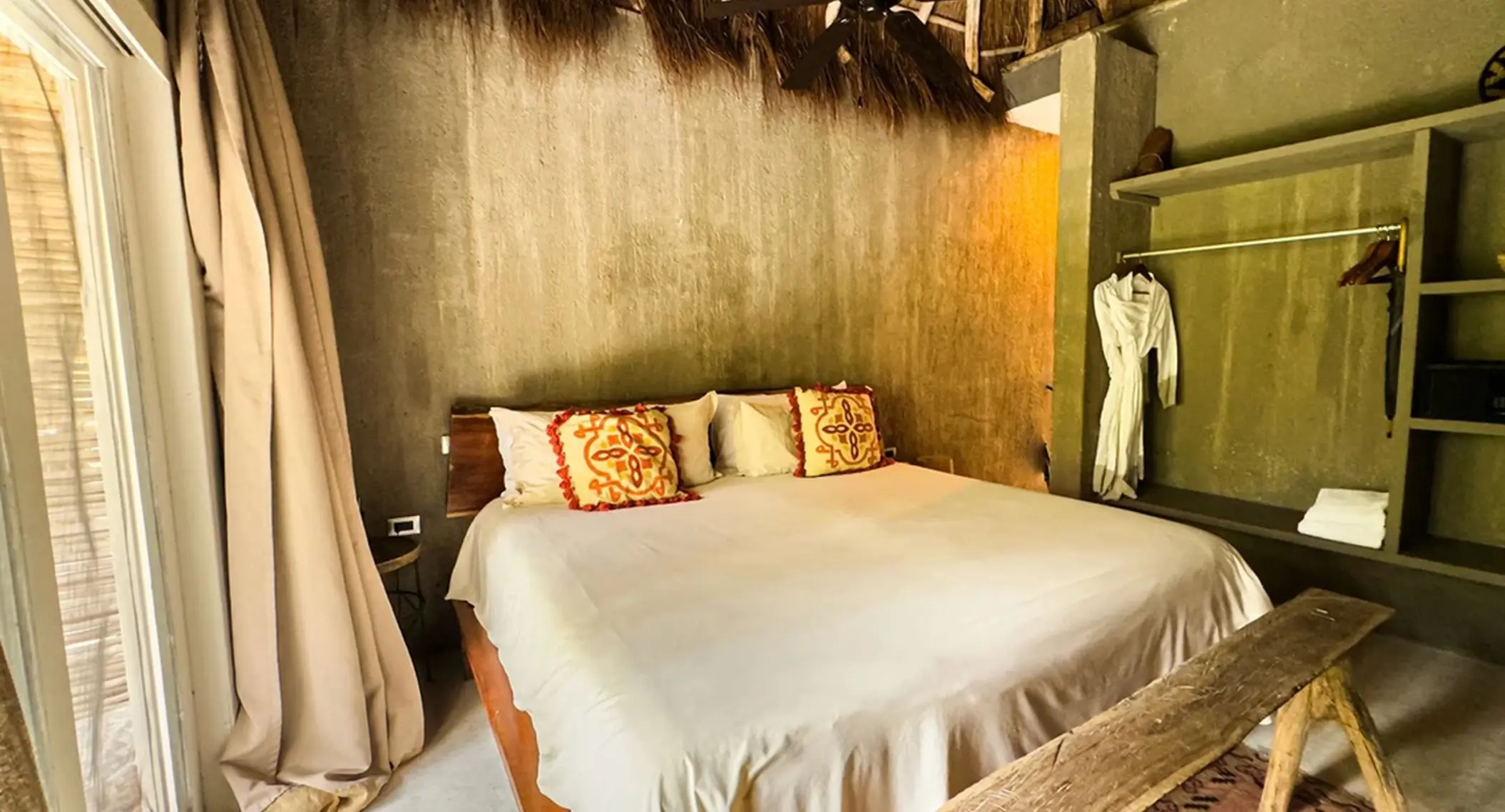 king bed inside room at nomade tulum