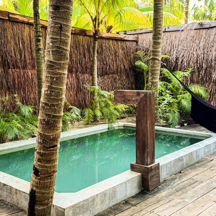 a suite's private pool and hammock at nomade tulum
