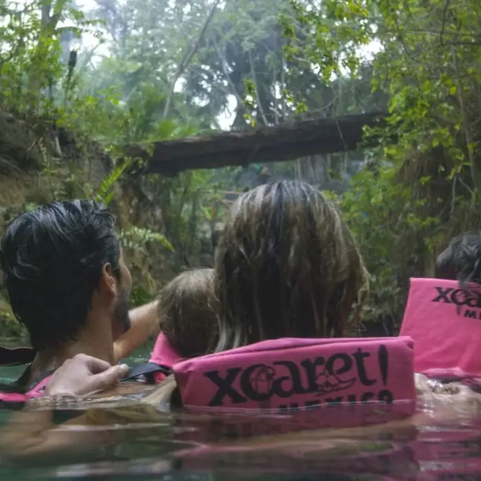 family swimming in the river at occidental at xcaret destination