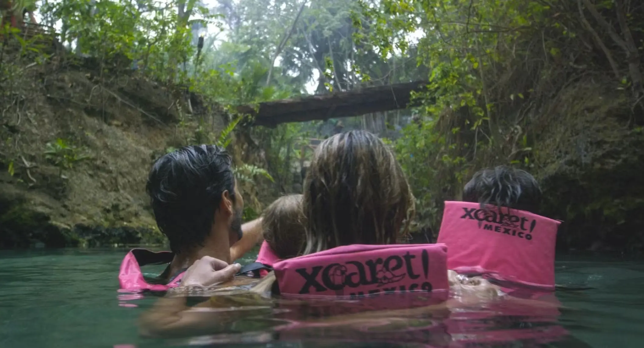 family swimming in the river at occidental at xcaret destination