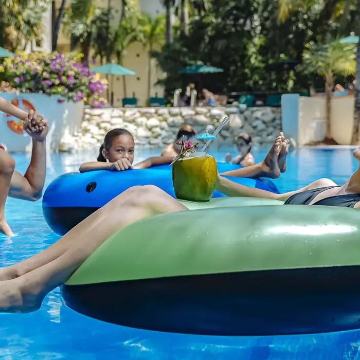 family in the pool at occidental at xcaret destination