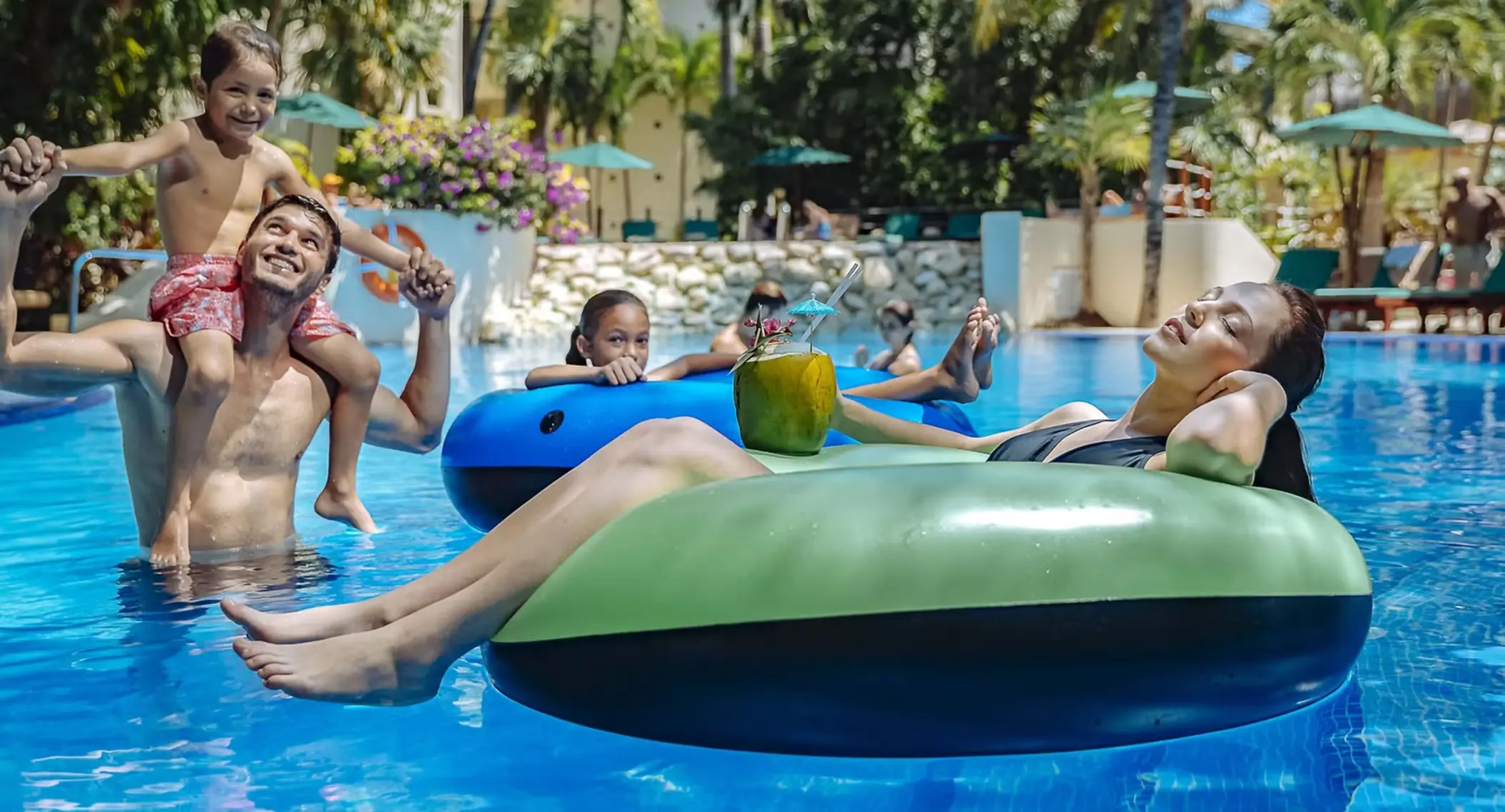 family in the pool at occidental at xcaret destination