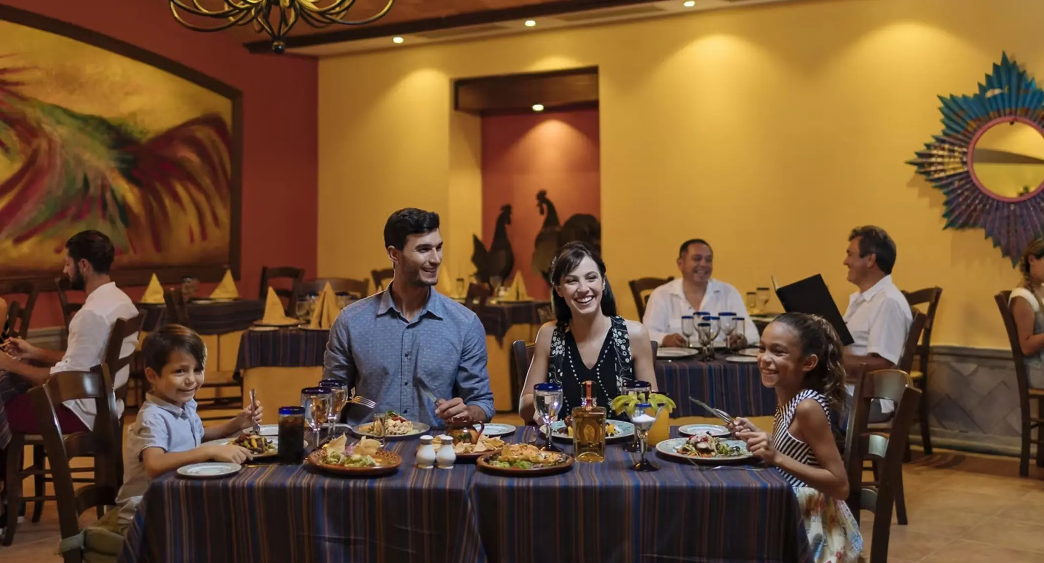family at a restaurant at occidental at xcaret destination