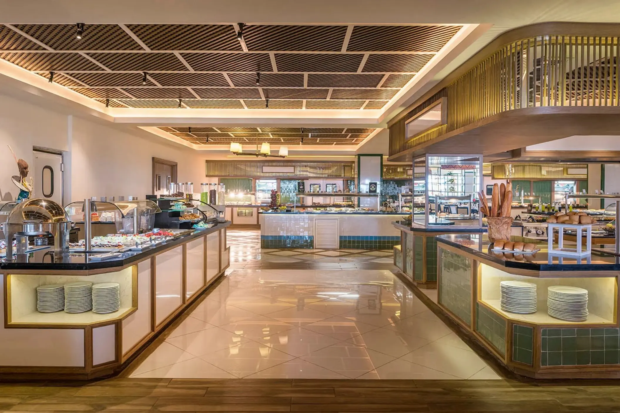 A modern, brightly lit buffet restaurant with various food stations and polished floors.