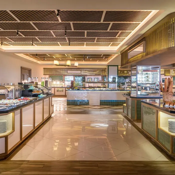 A modern, brightly lit buffet restaurant with various food stations and polished floors.