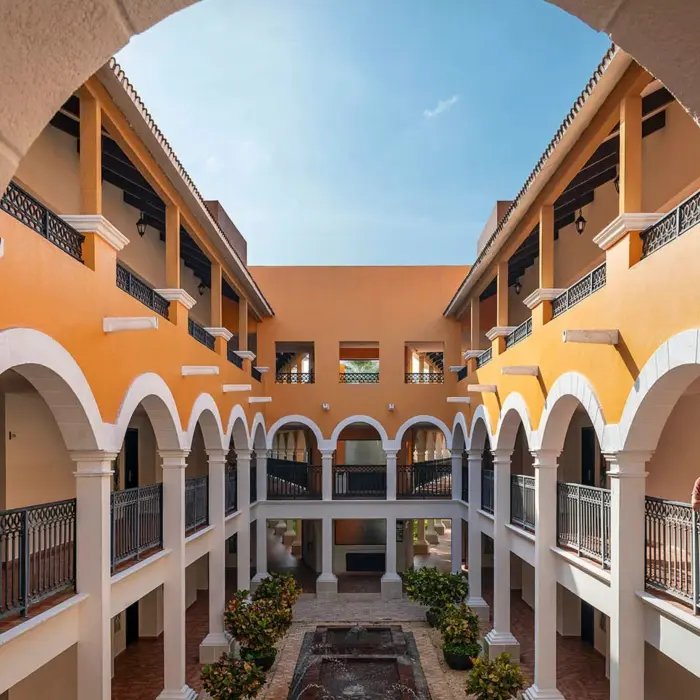 A view of the resort's stunning architecture with a central courtyard and arched balconies.