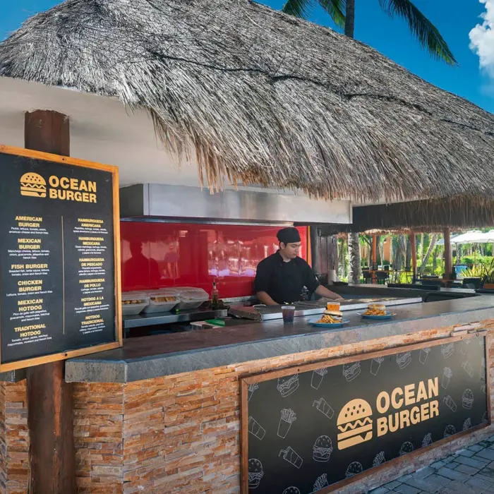An outdoor food shack with a thatched roof and 