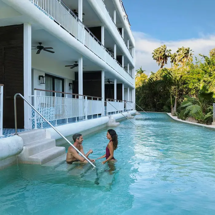 couple outside their swim out suite at Ocean Riviera Paradise