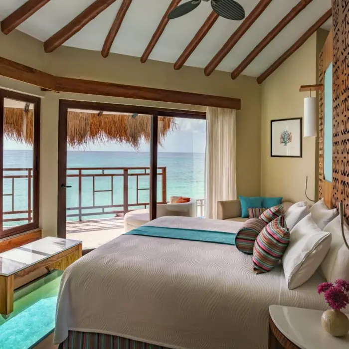 bed overlooking the sea at Palafitos Overwater Bungalows