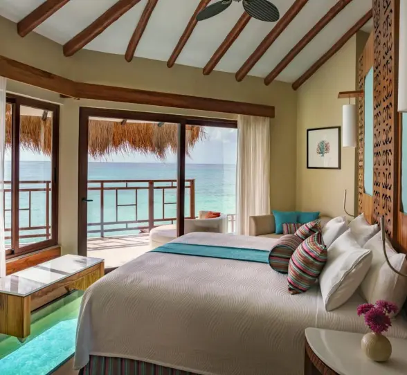 bed overlooking the sea at Palafitos Overwater Bungalows