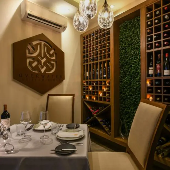wine cellar at Palafitos Overwater Bungalows with a table laid out