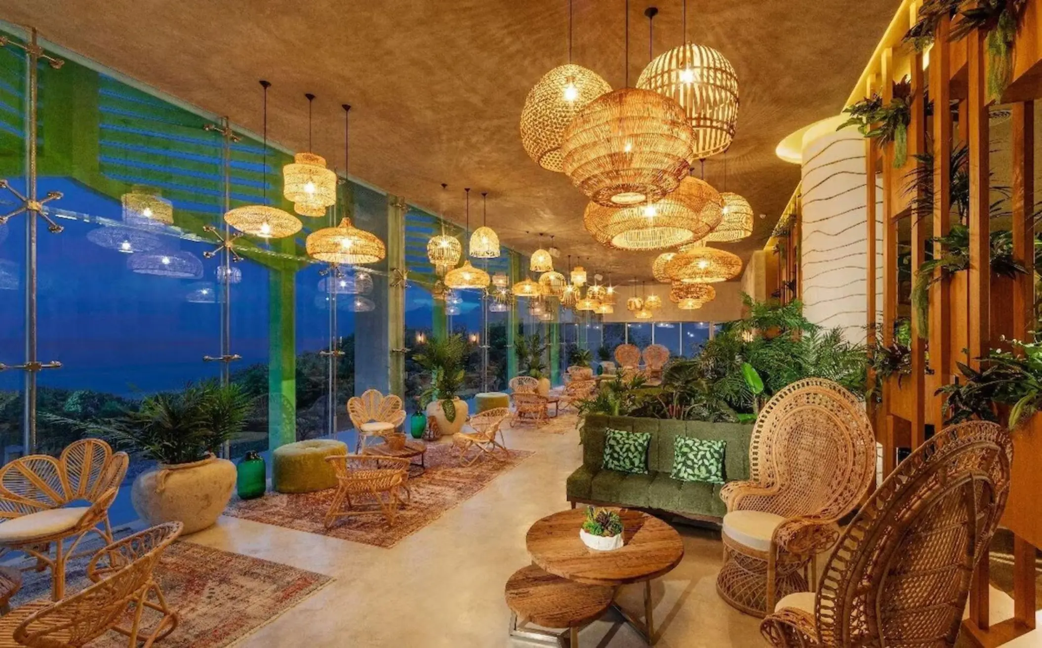 Cozy, plant-filled coffee shop with modern seating at Palmaïa - The House of AïA resort in Mexico