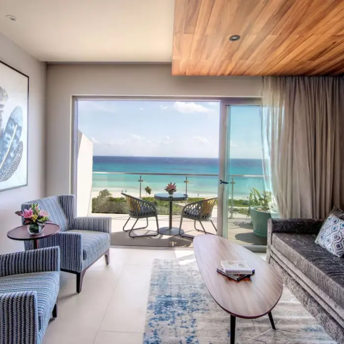 Stylish king suite living area with neutral tones and seating space at Palmaïa – The House of AïA