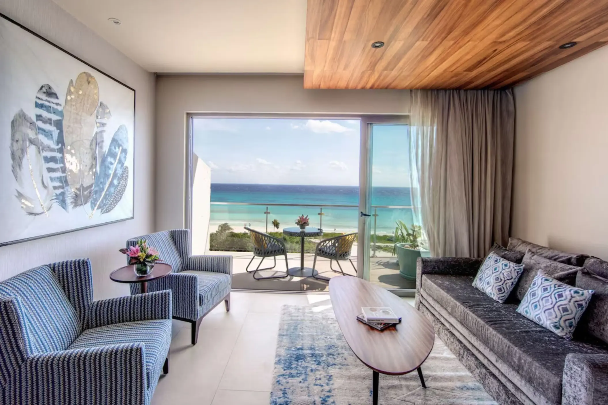 Stylish king suite living area with neutral tones and seating space at Palmaïa – The House of AïA