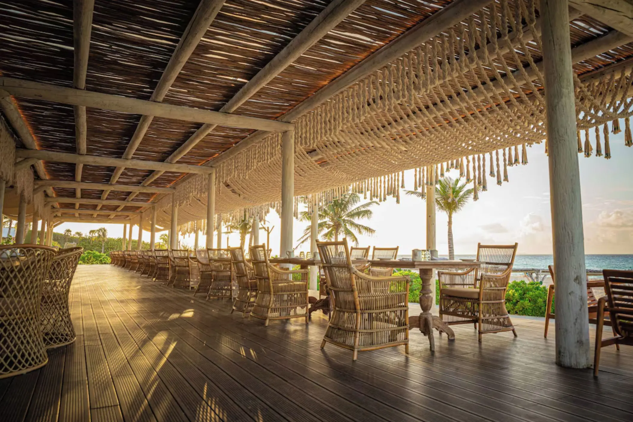 Oceanview restaurant with open-air seating at Palmaïa – The House of AïA luxury resort