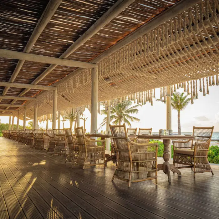 Oceanview restaurant with open-air seating at Palmaïa – The House of AïA luxury resort