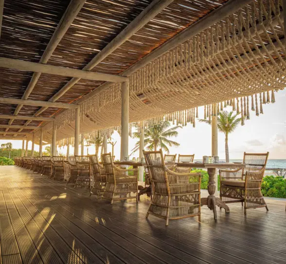 Oceanview restaurant with open-air seating at Palmaïa – The House of AïA luxury resort