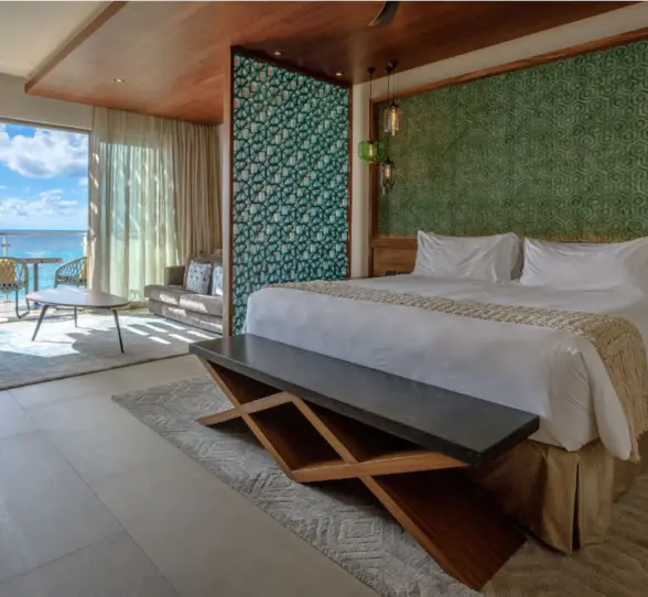 Spacious oceanview suite with contemporary decor and balcony at Palmaïa – The House of AïA