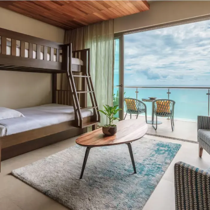 Family suite bedroom with bunk beds and modern decor at Palmaïa – The House of AïA resort