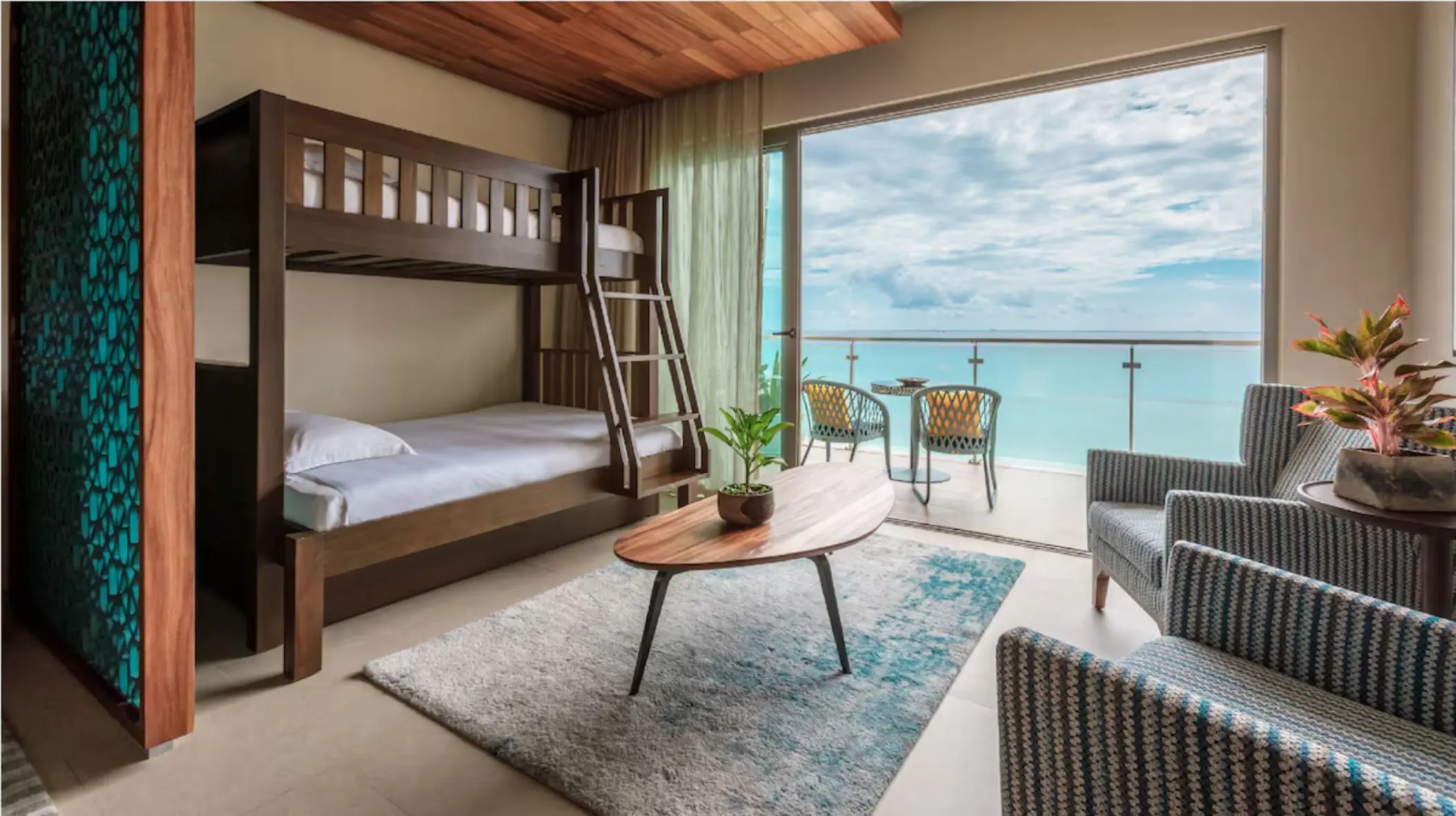 Family suite bedroom with bunk beds and modern decor at Palmaïa – The House of AïA resort