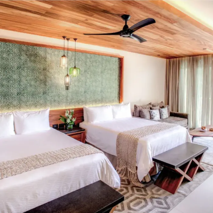 spacious suite with 2 queen size beds at Palmaïa – The House of AïA resort