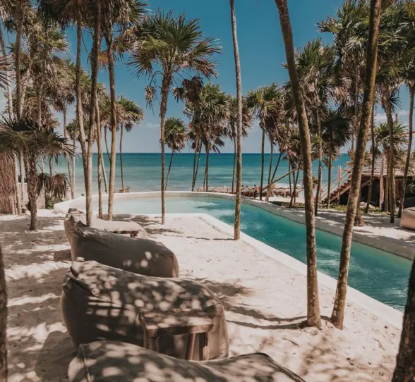 pool and loungers on the beach at Papaya Playa Project