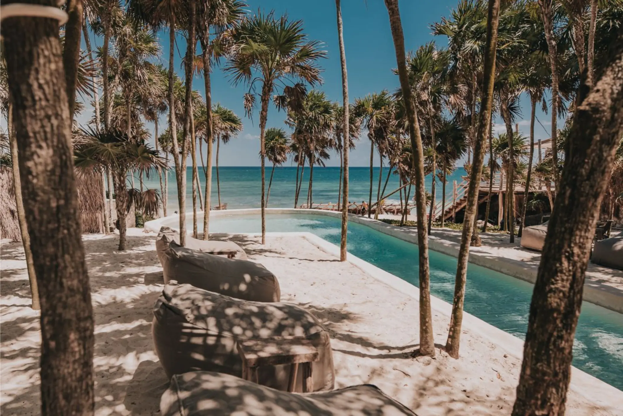pool and loungers on the beach at Papaya Playa Project