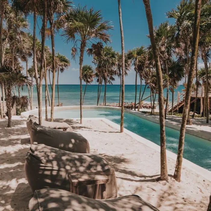 pool and loungers on the beach at Papaya Playa Project