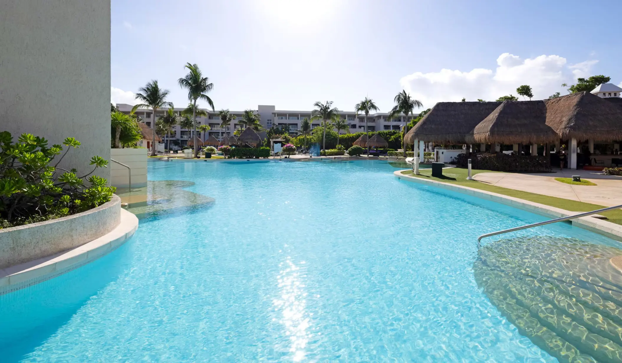 pool and palapas and resort buildings at Paradisus Playa del Carmen