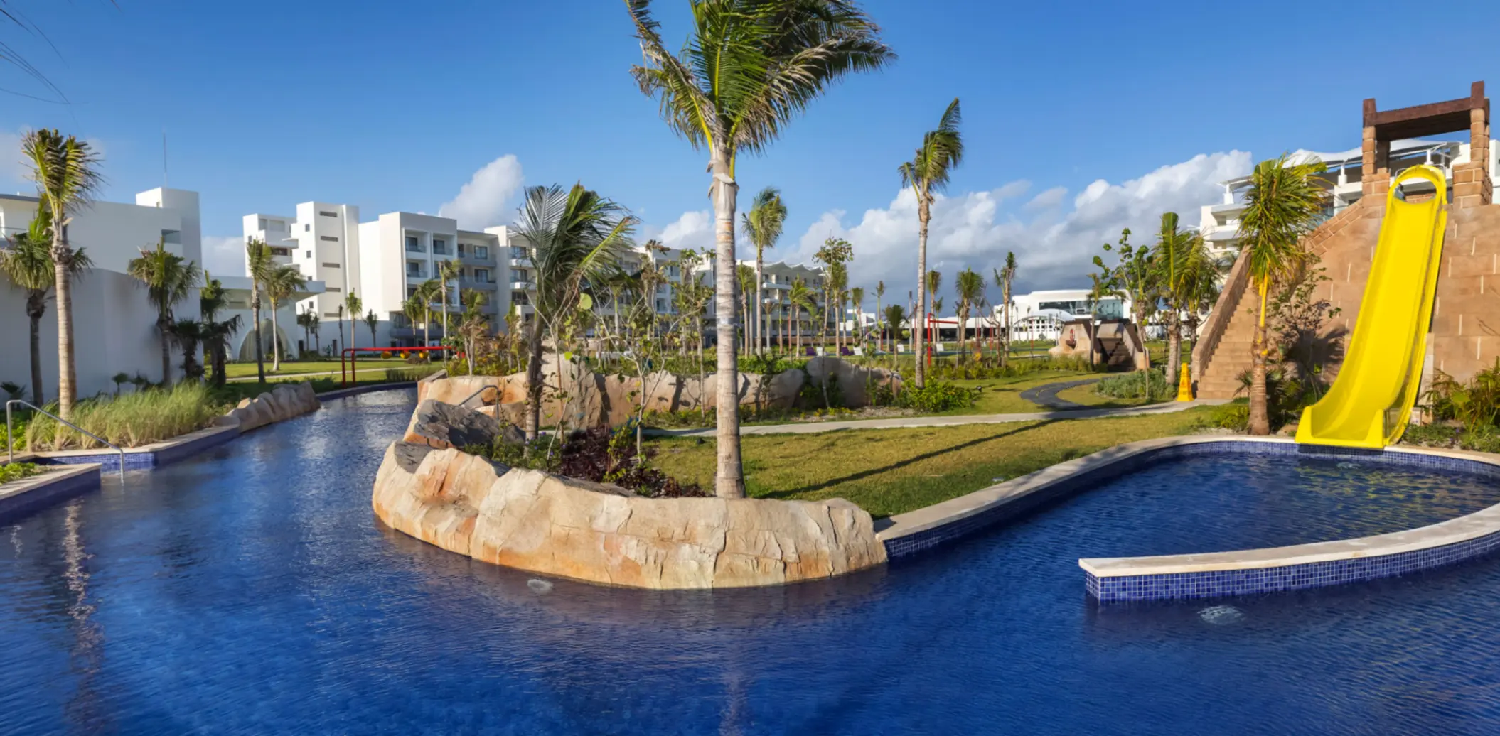 Stylish lounge with star-themed decor, curved purple sofas, and bar area in a resort entertainment space.