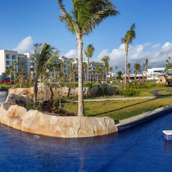 Stylish lounge with star-themed decor, curved purple sofas, and bar area in a resort entertainment space.