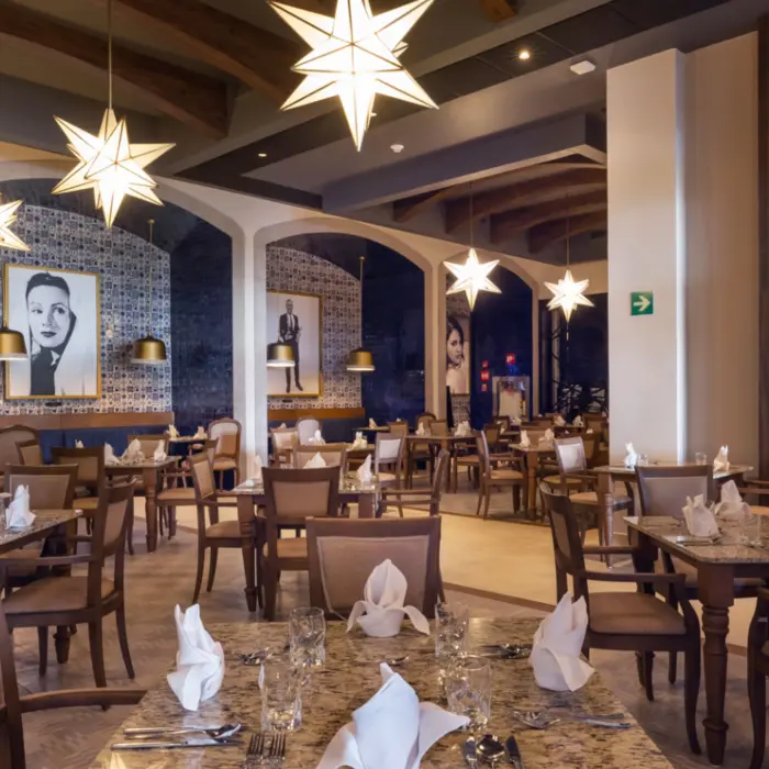 Mexican-style restaurant with tile walls, rustic wood decor, and portraits of classic film icons.