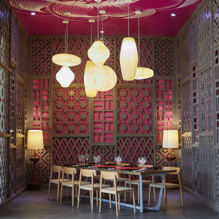 The Kotatsu restaurant dining area with unique lighting fixtures, pink decor, and wooden lattice screens.