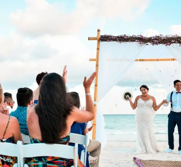bride groom and guests during a beach ceremony at Playacar Palace