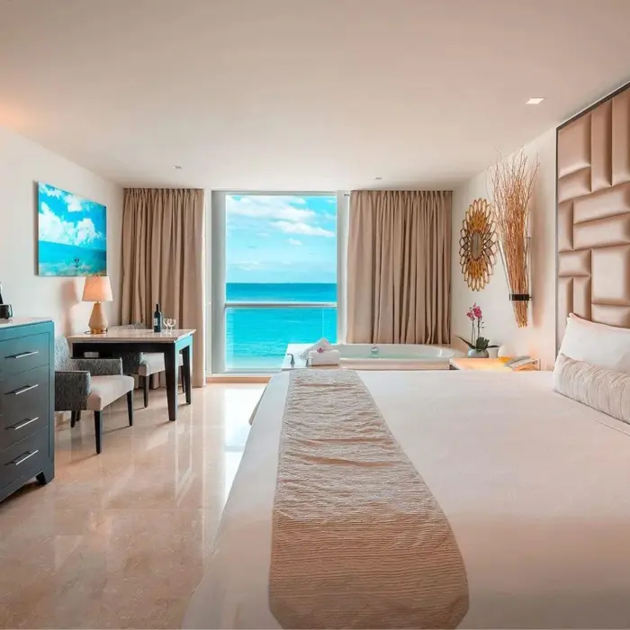 suite with hot tub and ocean views and king bed at Playacar Palace