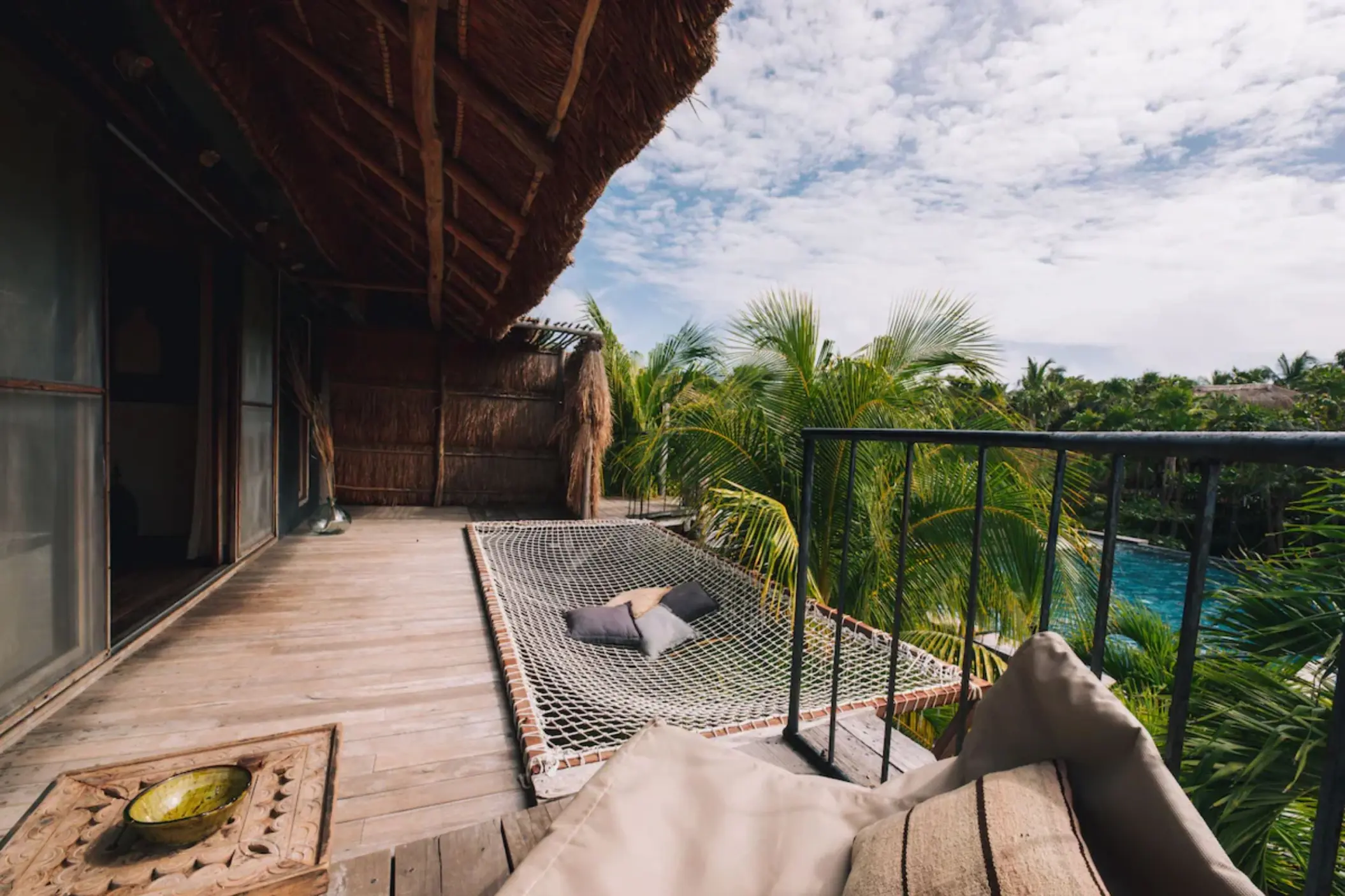 balcony of suite with the view of the pool at Radhoo Tulum