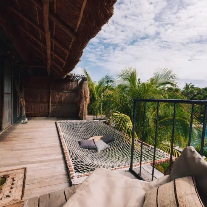 balcony of suite with the view of the pool at Radhoo Tulum