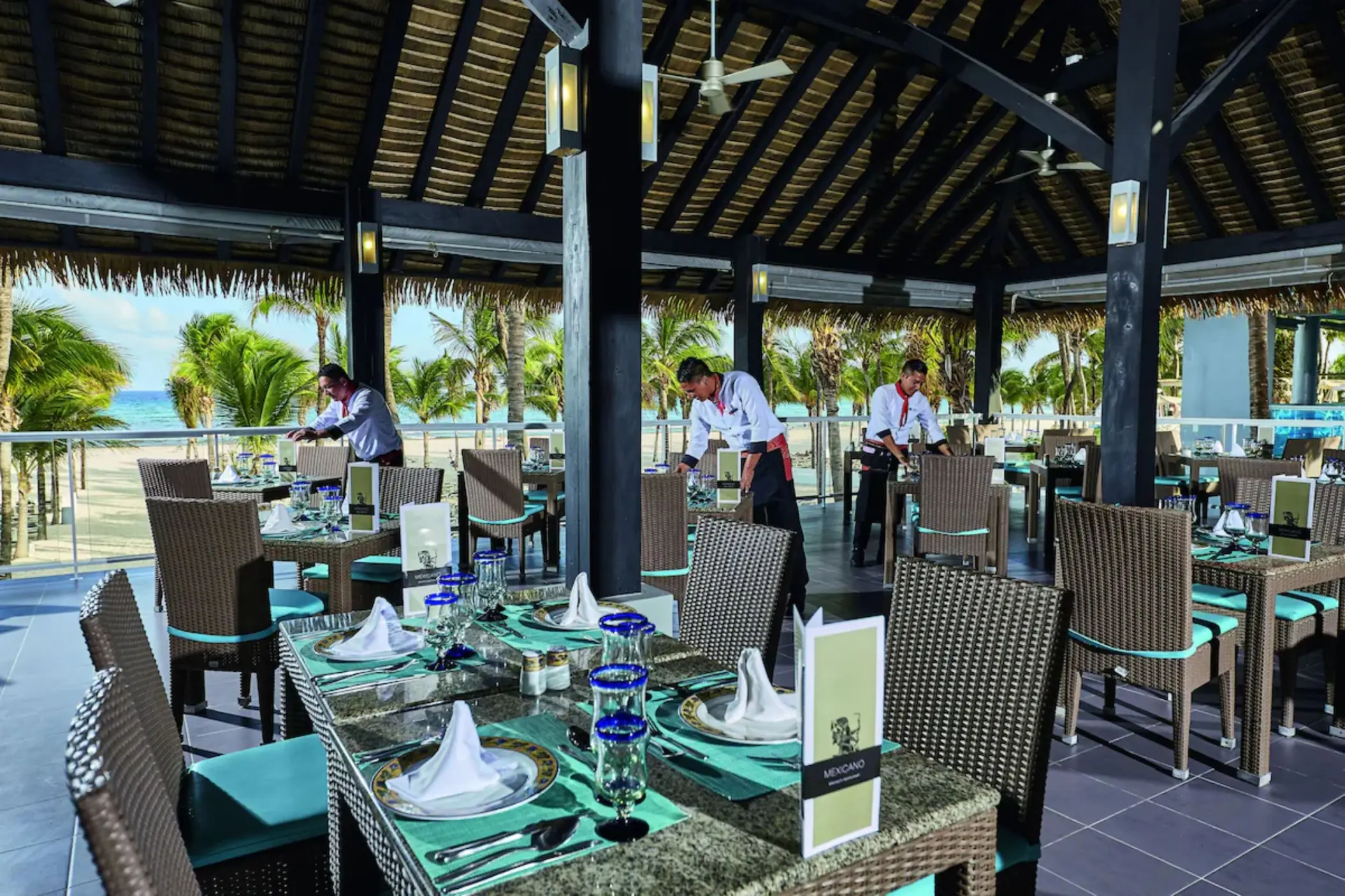 An elegant buffet restaurant with multiple food counters, decorative wall art, and a high ceiling.