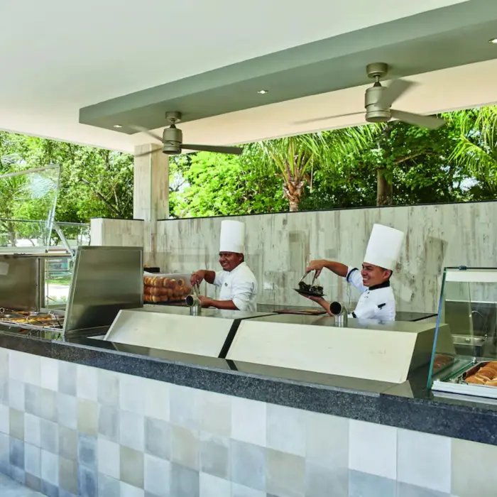 A brightly lit snack bar with a buffet counter and a variety of food items.