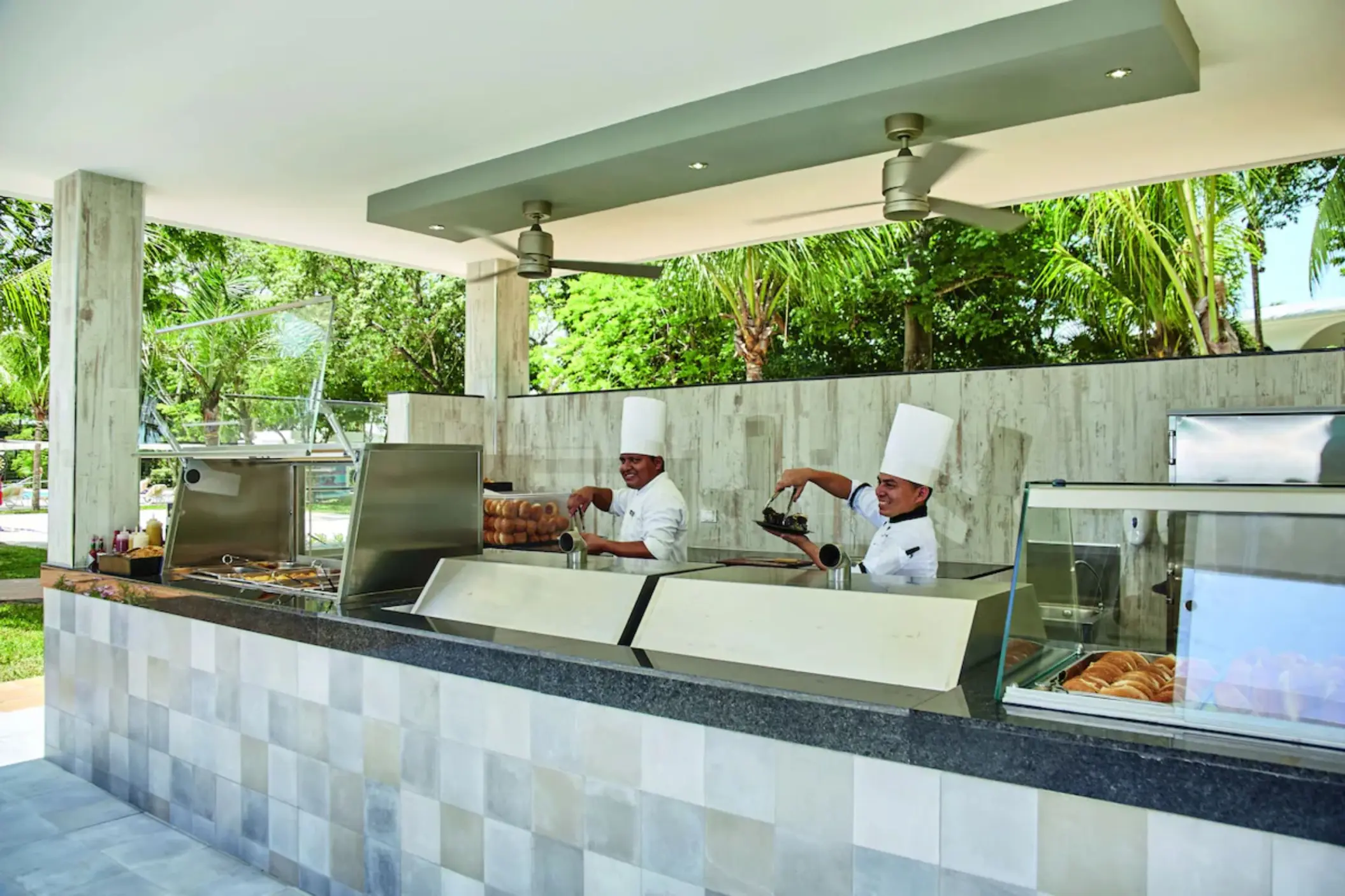 A brightly lit snack bar with a buffet counter and a variety of food items.