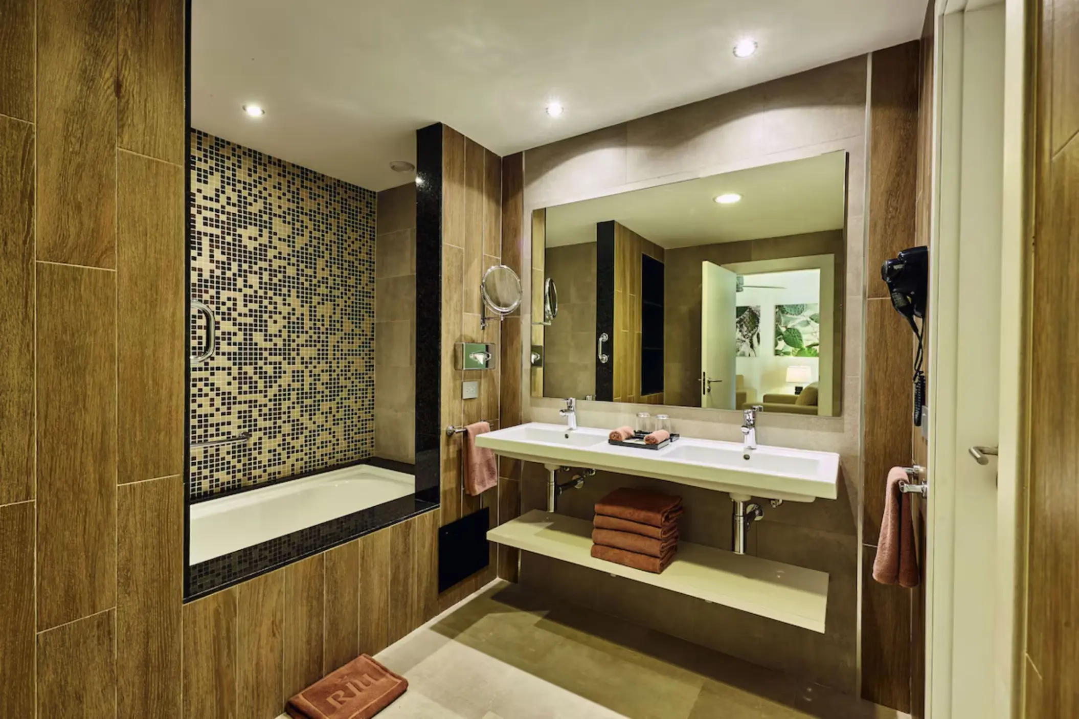 A modern bathroom with two sinks, a walk-in shower, and a spacious layout.