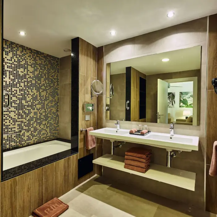 A modern bathroom with two sinks, a walk-in shower, and a spacious layout.