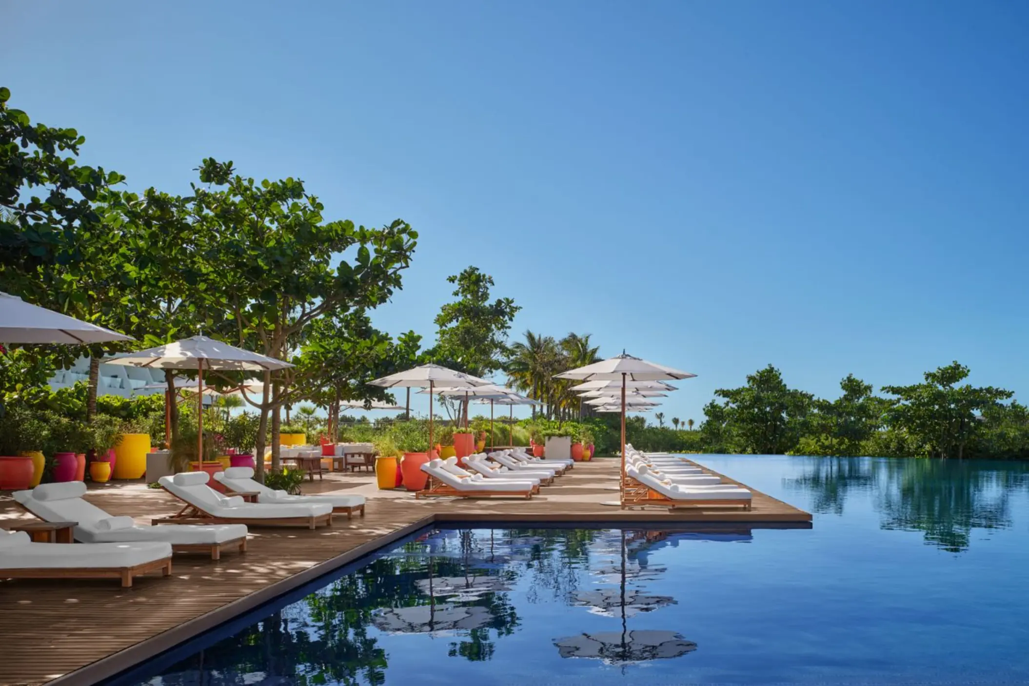 main pool with sunbeds at The Riviera Maya EDITION at Kanai