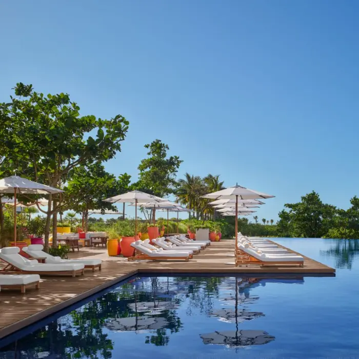 main pool with sunbeds at The Riviera Maya EDITION at Kanai