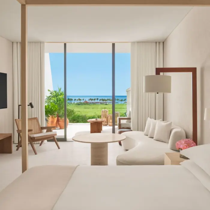 obsidian suite living room and king bed with ocean view at The Riviera Maya EDITION at Kanai