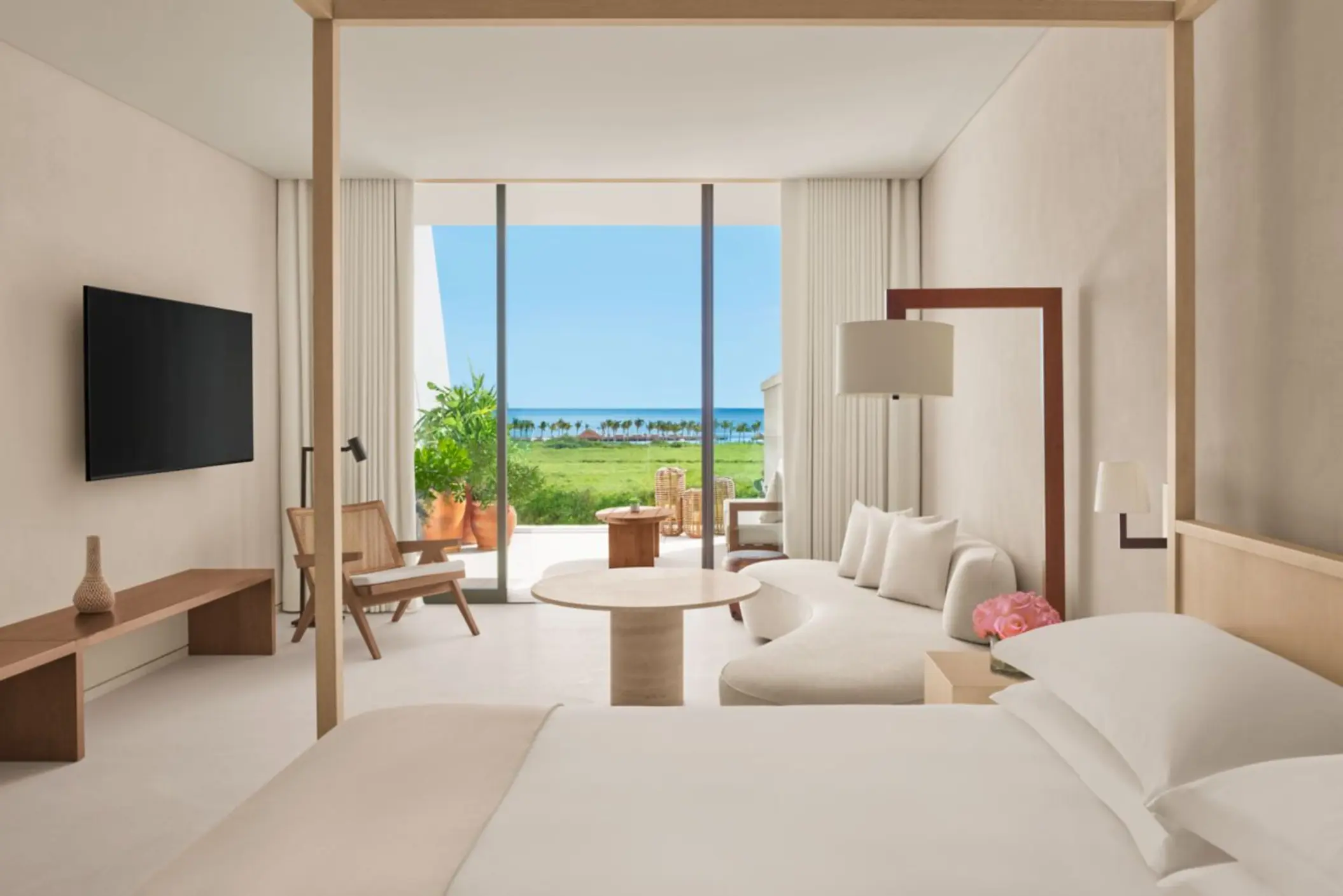 obsidian suite living room and king bed with ocean view at The Riviera Maya EDITION at Kanai